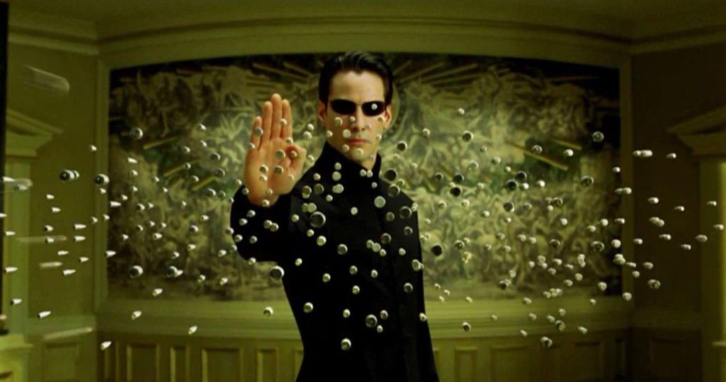 پوستر فیلم علمی تخیلی The Matrix با کدهای سبز و صحنه‌های اکشن در دنیای دیجیتال